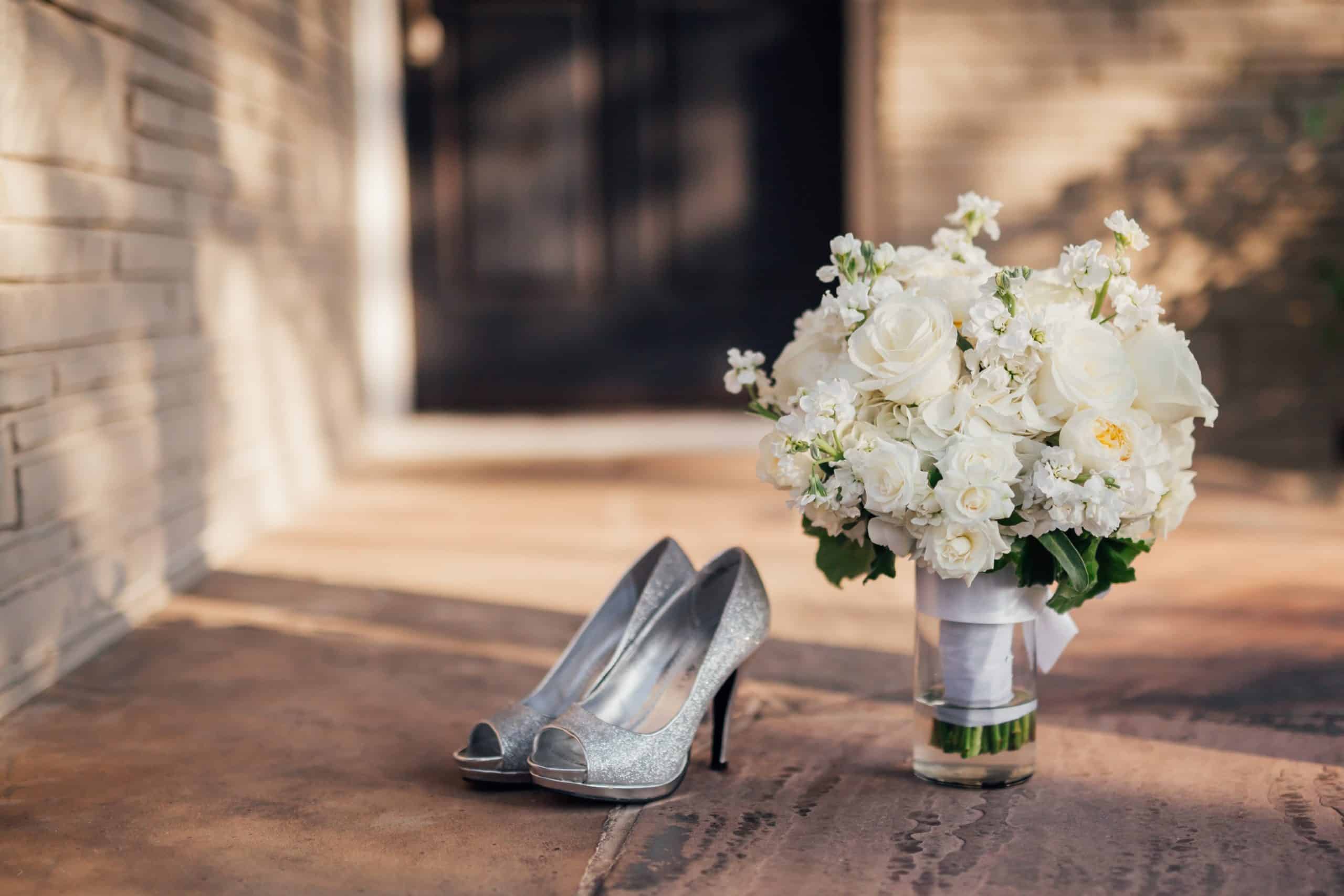 fancy-shoes-sit-next-to-a-wedding-bouquet-2022-11-15-11-55-07-utc