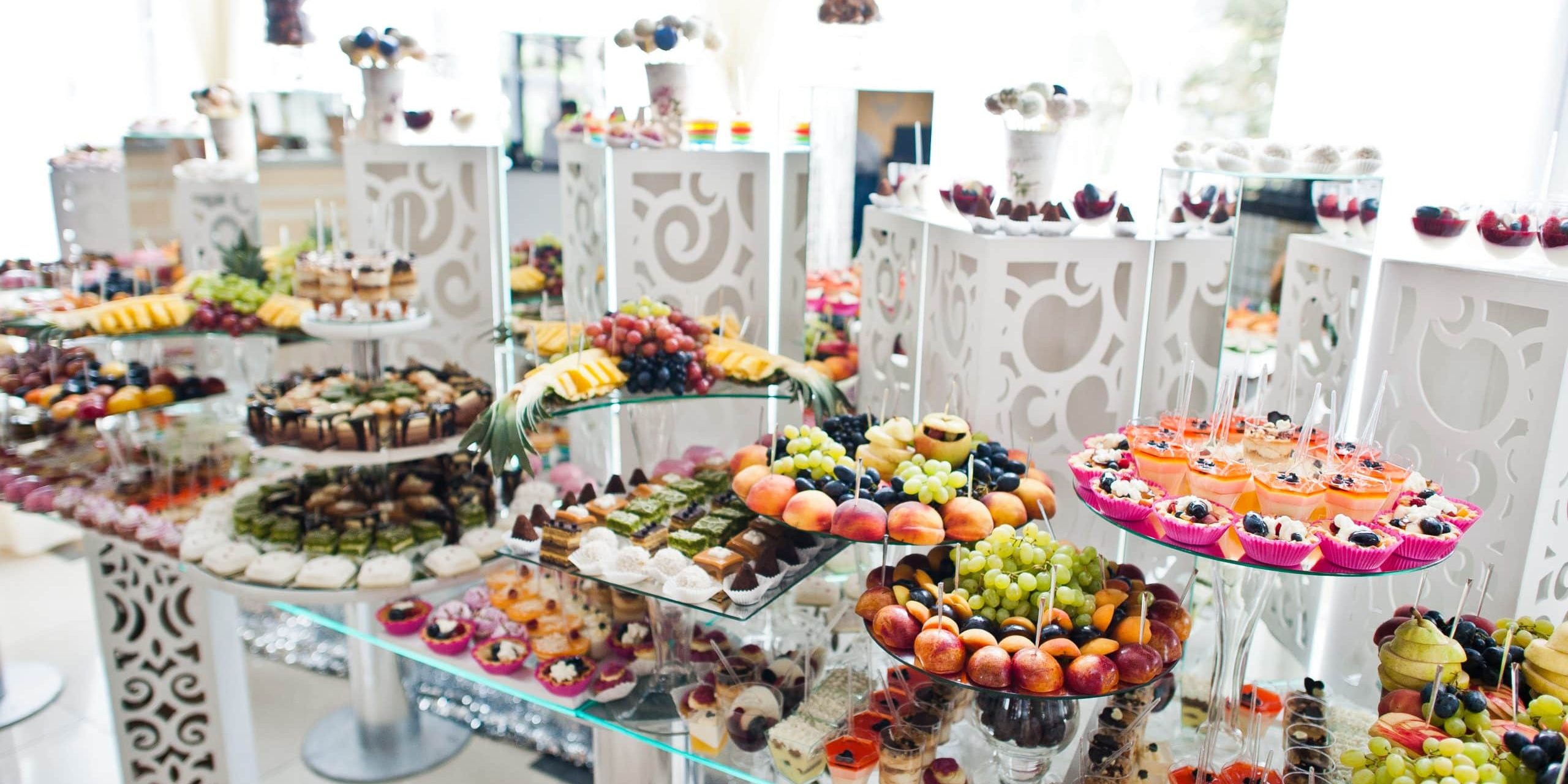 Beautiful wedding candy bar with sweets, fruits and food. Wedding banquet table