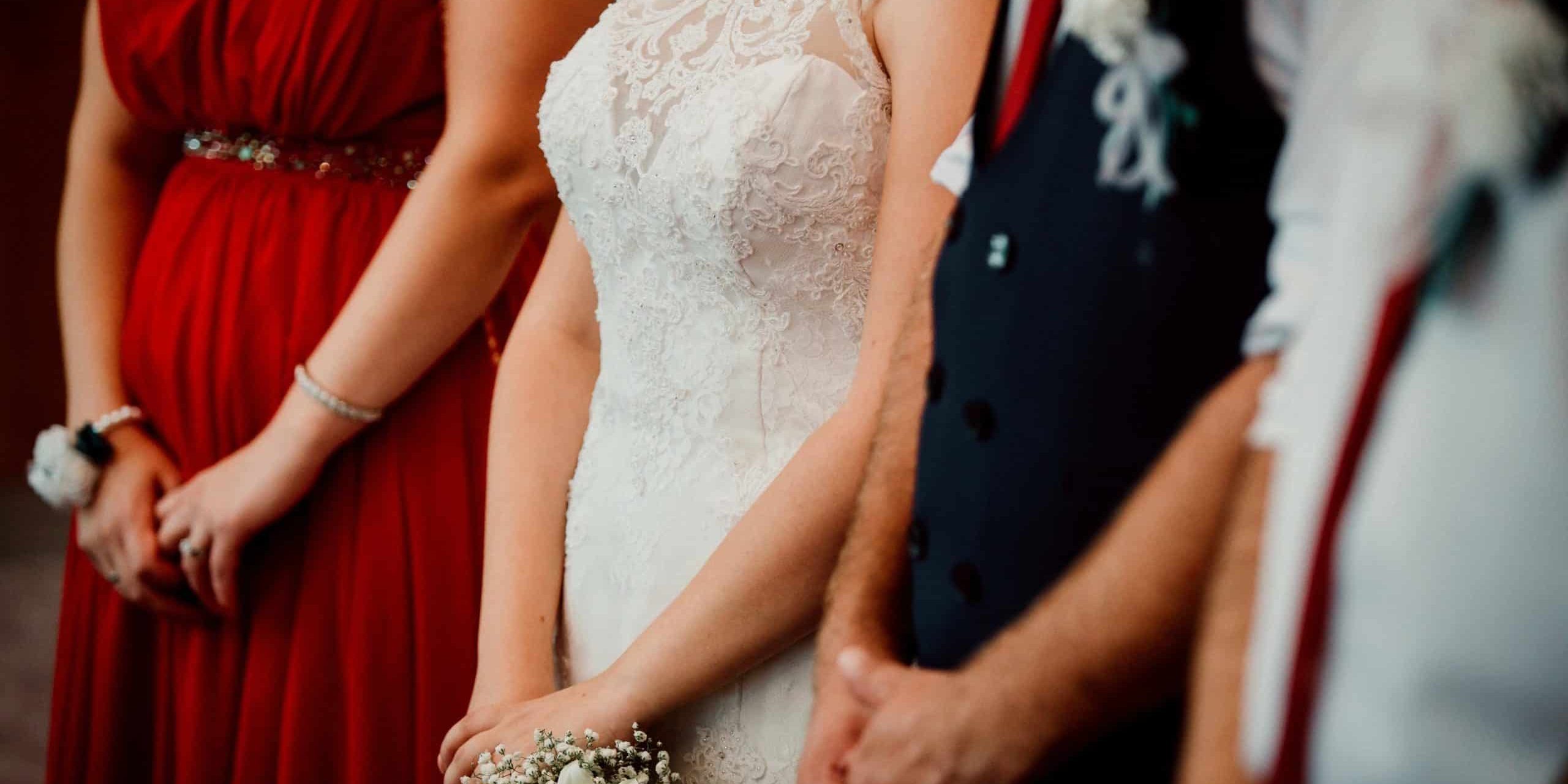 A close up shot of hands of bride, groom, bridesmaid, maid in honor