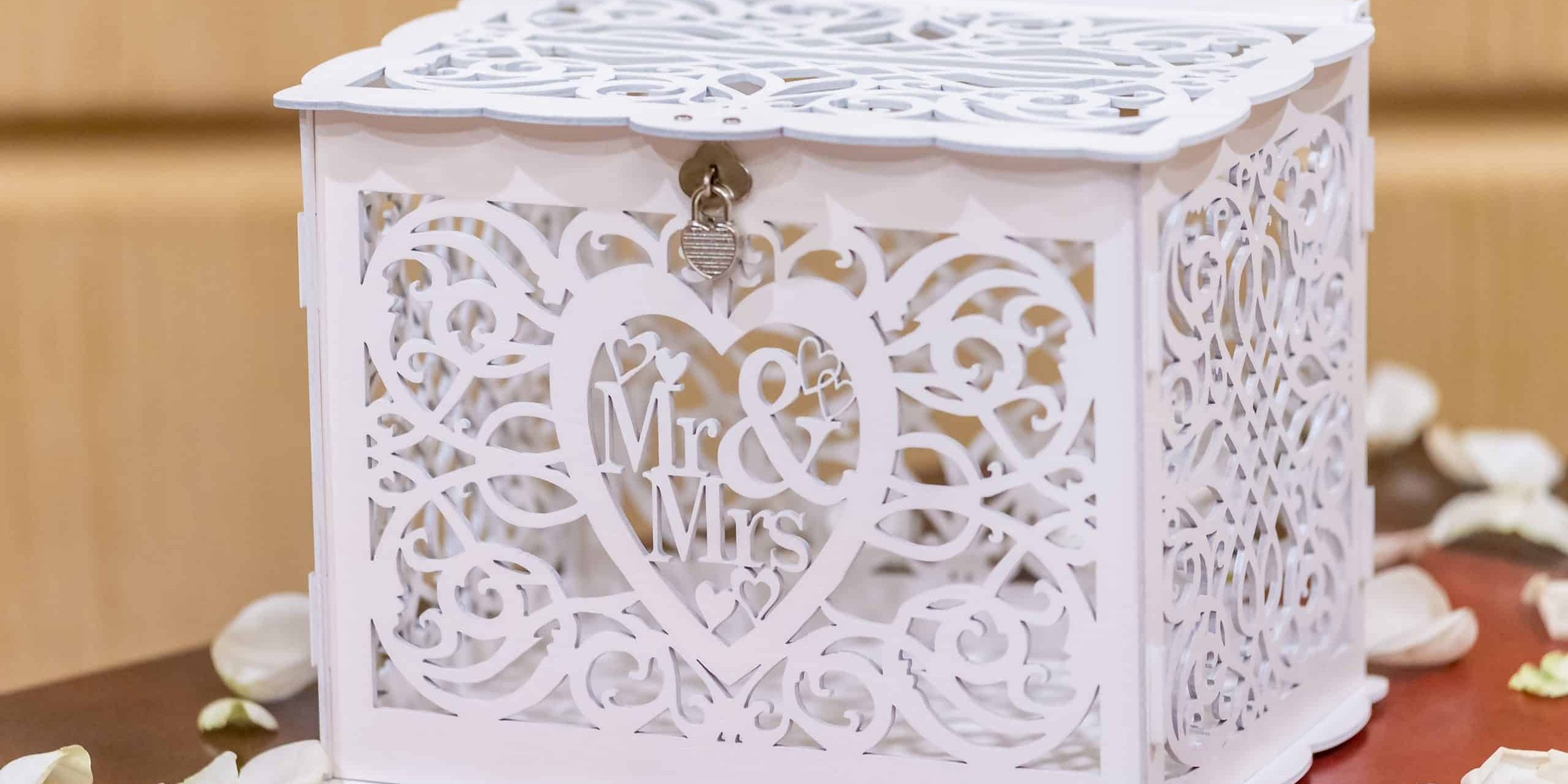 A closeup shot of an elegant wooden white wedding gift box with the writing "Mr and Mrs"