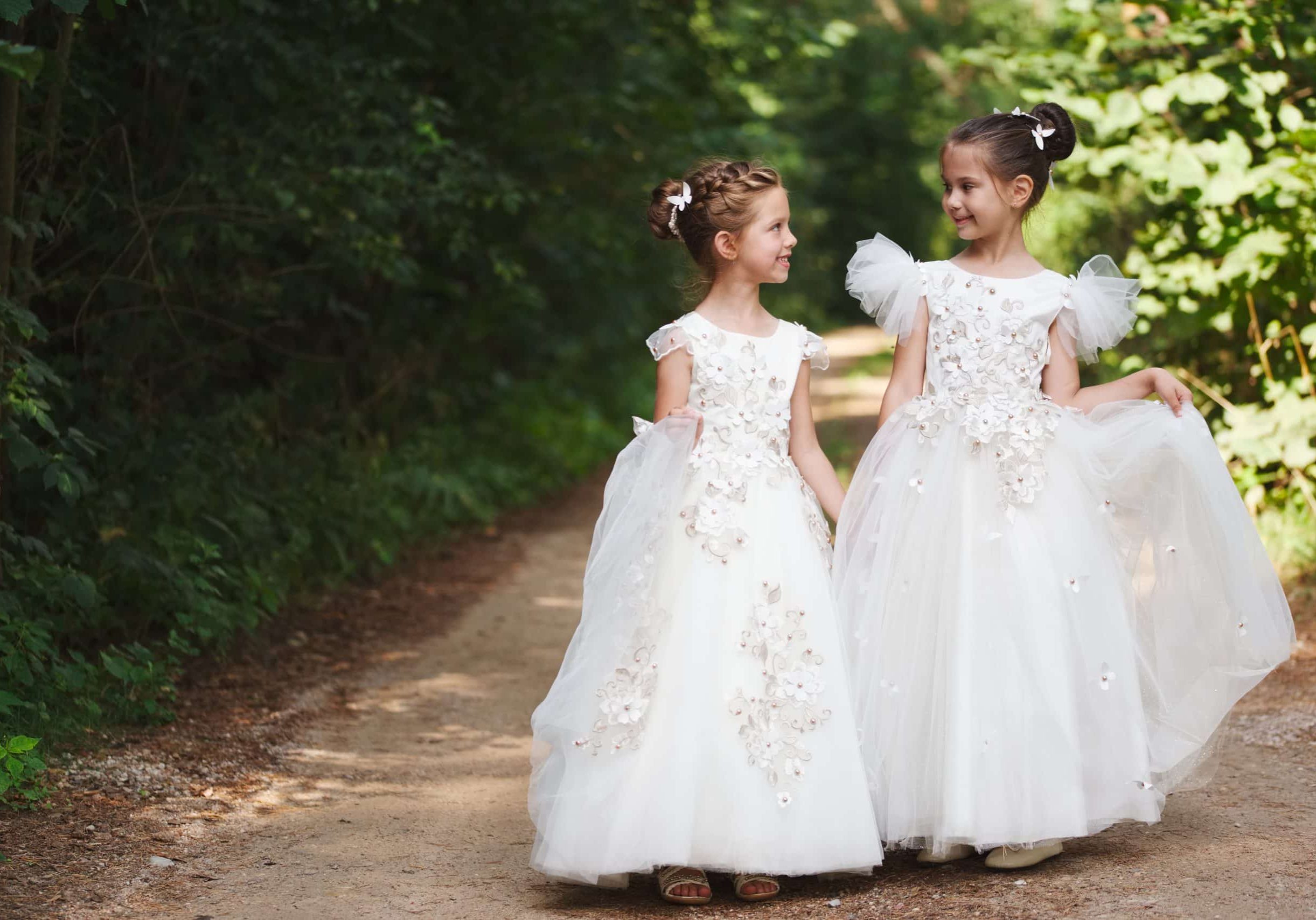 two happy beautiful girls with white wedding dresses