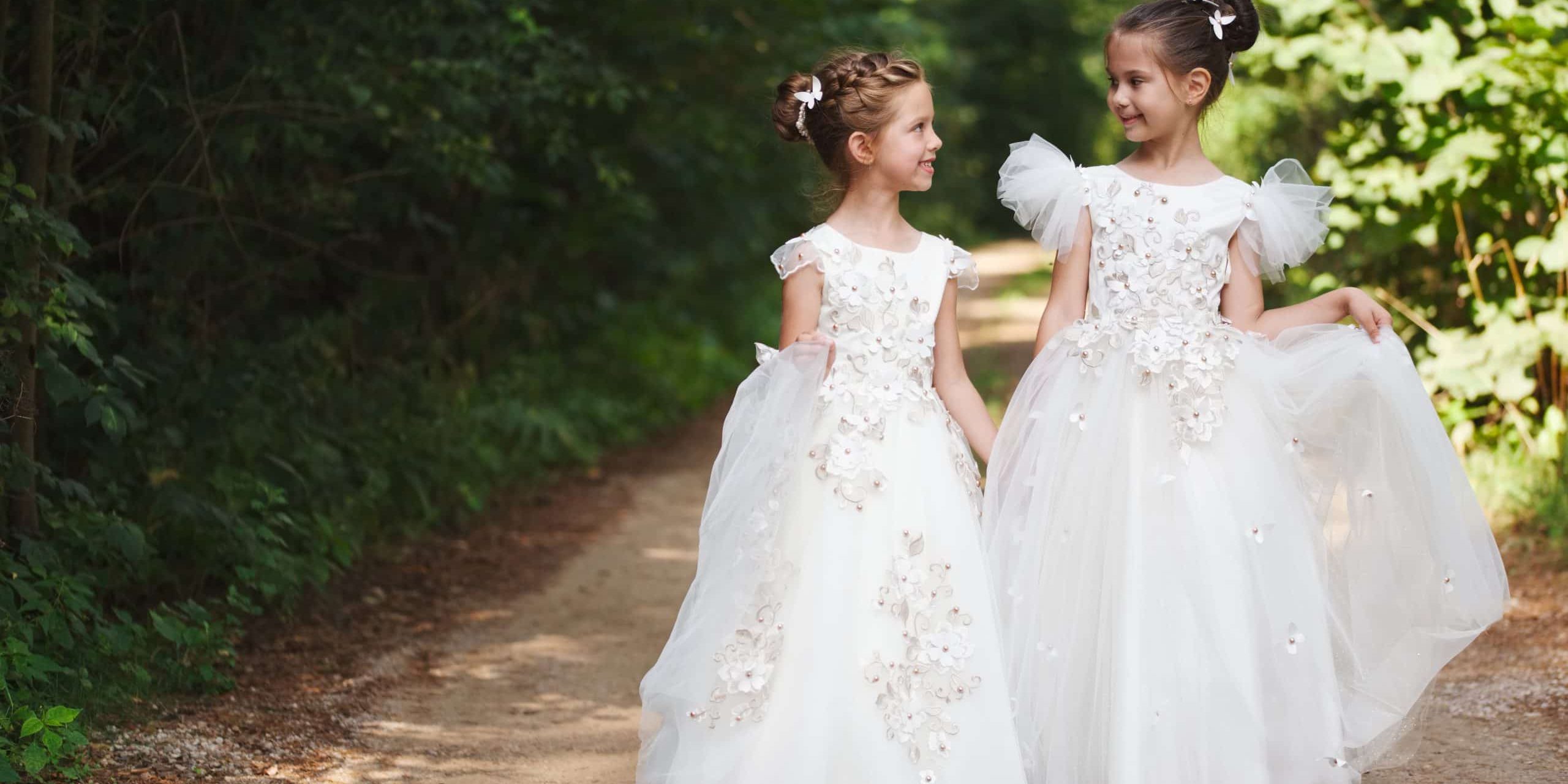 two happy beautiful girls with white wedding dresses